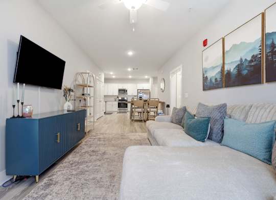 A living room with a blue cabinet and a flat screen TV mounted on the wall.
