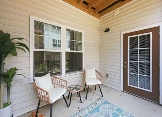 A patio with a chair and table.