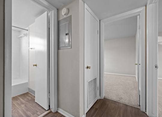 A white door is open to a room with a carpet.