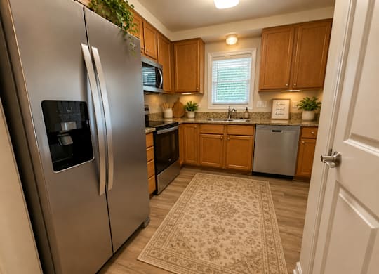A kitchen with a refrigerator and a sink.
