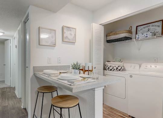 A small laundry room with a washer and dryer.