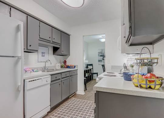 A kitchen with a white refrigerator and a white washing machine.