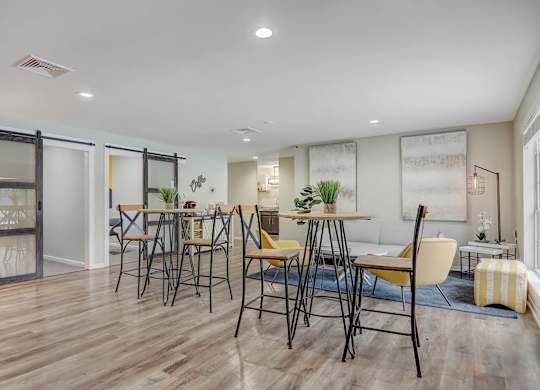 A dining room with a table set for four.
