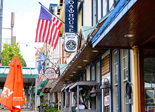 a city street with tables and chairs and flags
