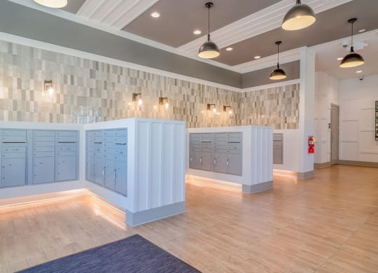 the locker room at the gym has blue lockers and a wood floor at Carmel Vista, McDonough, GA