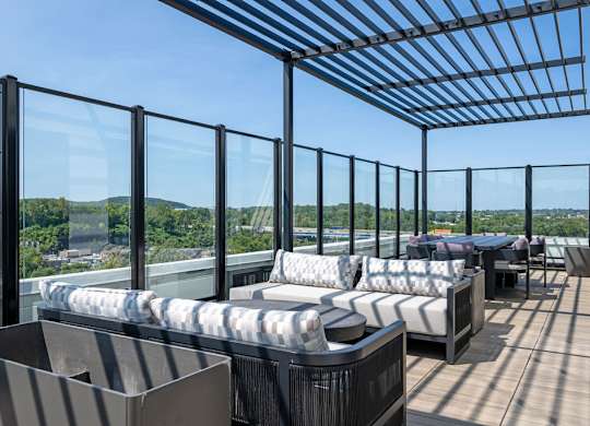 a terrace with couches and tables on a roof