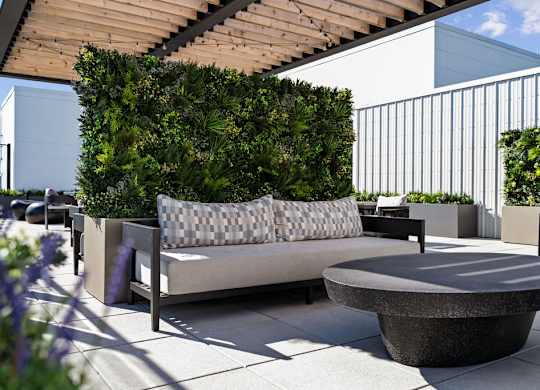 a seating area with a couch and a table on a patio