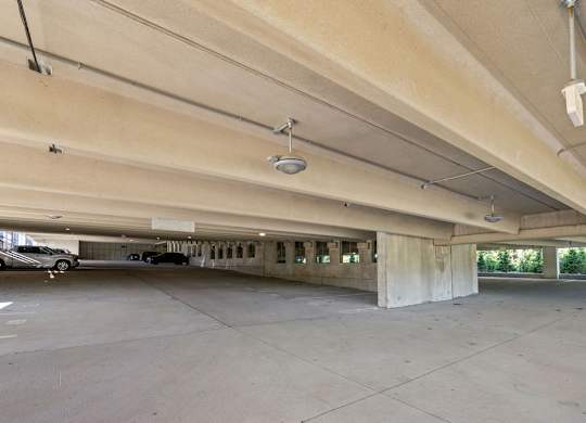 an empty parking garage with cars parked in it