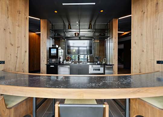 a view of a kitchen with a bar and a table