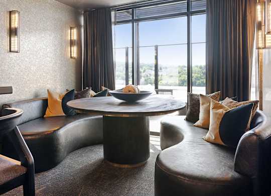 a living room with couches and a table with a bowl