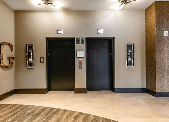 a lobby with two elevators and two doors