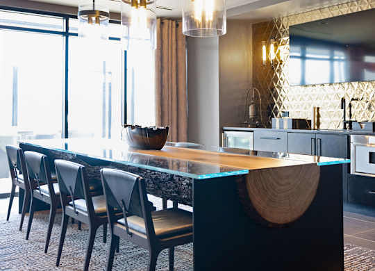 a large kitchen with a long table and chairs
