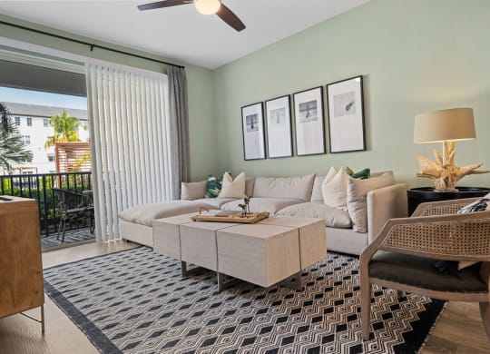 a living room with a couch and a table at Inspira, Naples, Florida