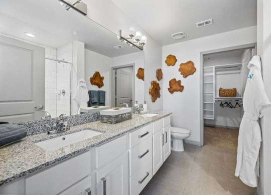 a bathroom with a sink and a toilet and a mirror at Inspira, Naples, 34113