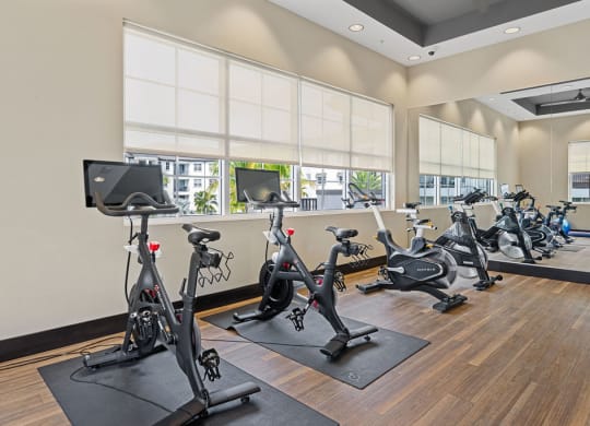 a gym with exercise bikes and other fitness equipment at Inspira, Naples, FL, 34113