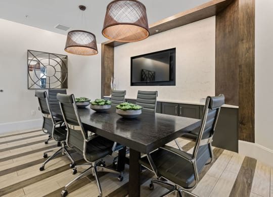 Conference table with TV for presentations available for use by residents at Inspira, Florida