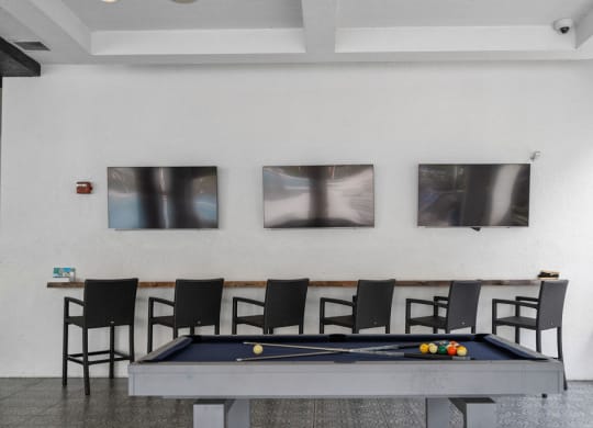 a pool table and chairs in a room with pictures on the wall at Inspira, Florida, 34113