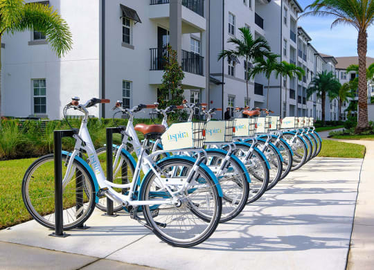 a row of bikes parked in front of an apartment building at Inspira, Naples, 34113
