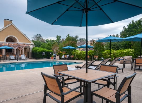 table and chairs under umbrella at the pool at Madison Glen Mills, Glen Mills, Pennsylvania