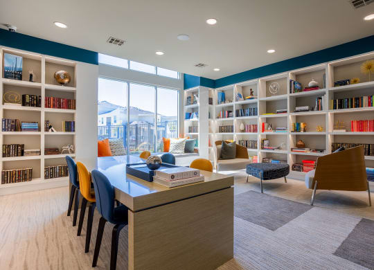 a library with bookshelves and a table and chairs