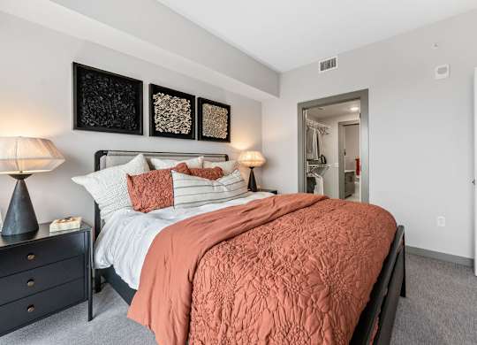 a bedroom with a bed and a door to a bathroom