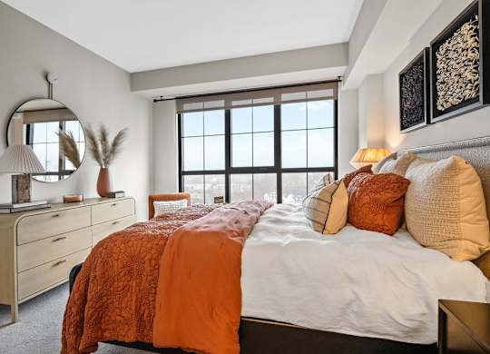 a bedroom with a large bed and a window