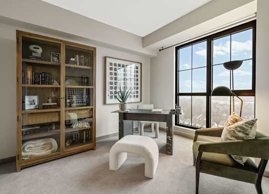 a living room filled with furniture and large windows