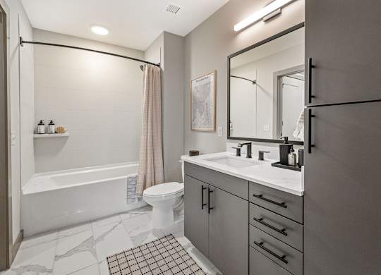 a white bathroom with a shower and a sink