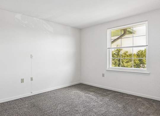A room with a window and a door.