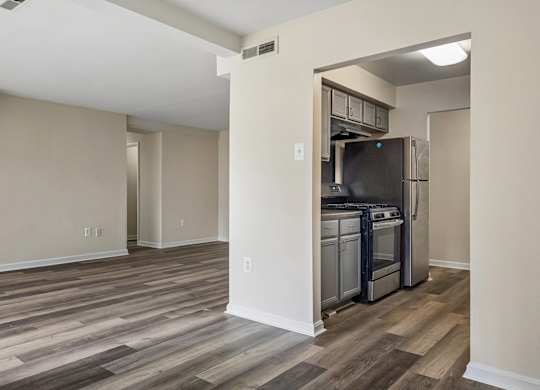 A kitchen area with a refrigerator, oven, and microwave.