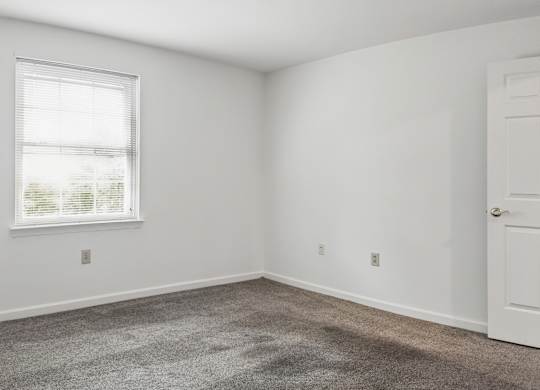 A room with a window and a door.