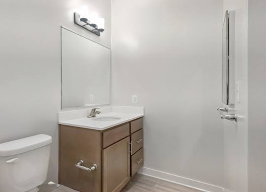 A white toilet sits next to a sink in a small bathroom.