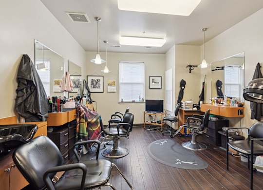 a salon room with chairs and mirrors