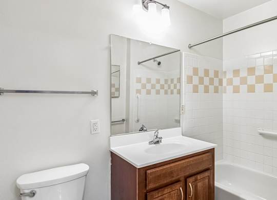 A white bathroom with a sink, toilet, and bathtub.