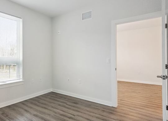 A room with a window and a door.