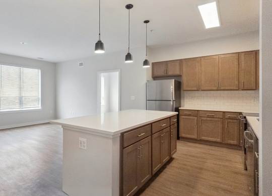 A kitchen with wooden cabinets and a white countertop.