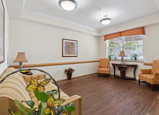 a living room filled with furniture and a large window