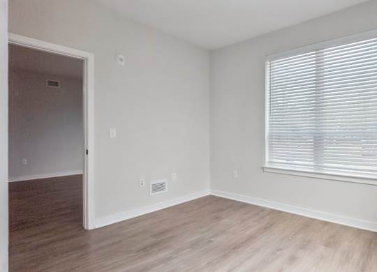 A room with a window and a door.