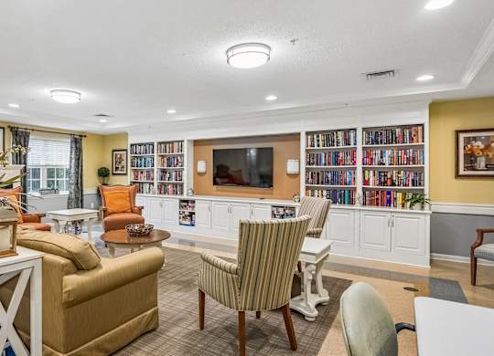 A living room with a white coffee table and a striped chair.