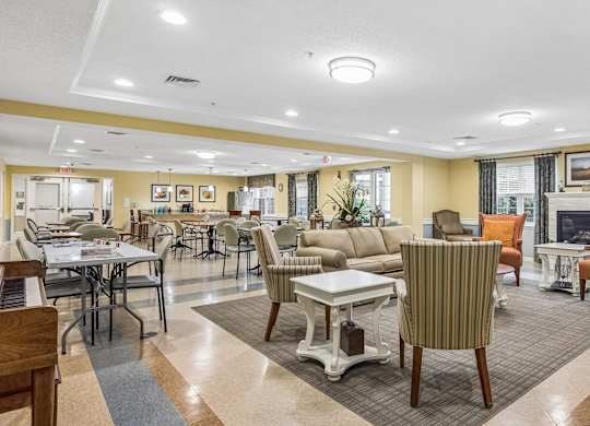 A spacious living room with a dining table and chairs.
