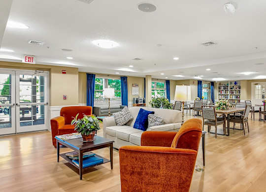 A living room with a fireplace and a dining table.