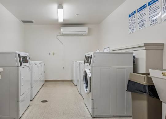 A laundry room with washers and dryers.