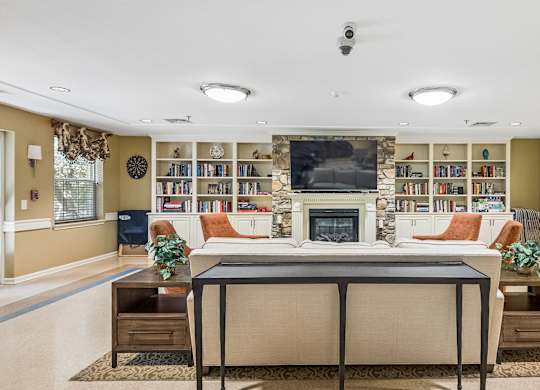 A living room with a fireplace and a bookshelf.