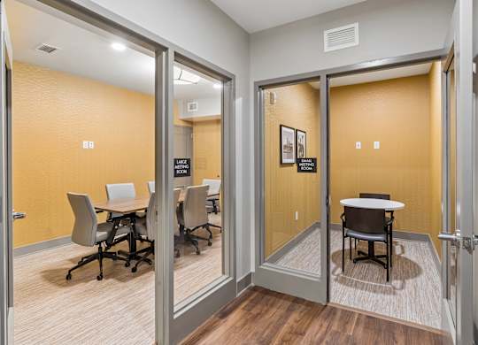 A conference room with a table and chairs.