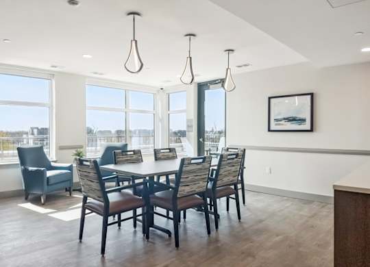 A dining room with a table and chairs.