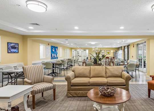 A living room with a couch, chairs, and a coffee table.