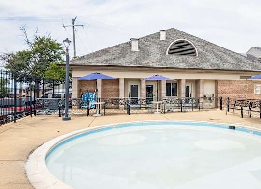 A small pool in front of a house.