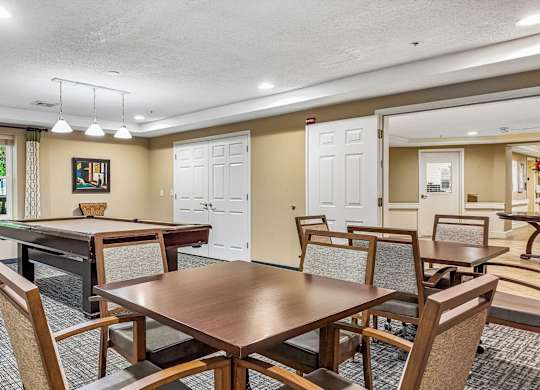 A conference room with a long table and chairs.