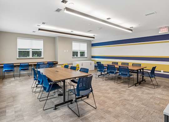 A conference room with a long table and chairs.