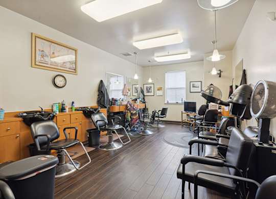 a room with a lot of chairs and a clock on the wall